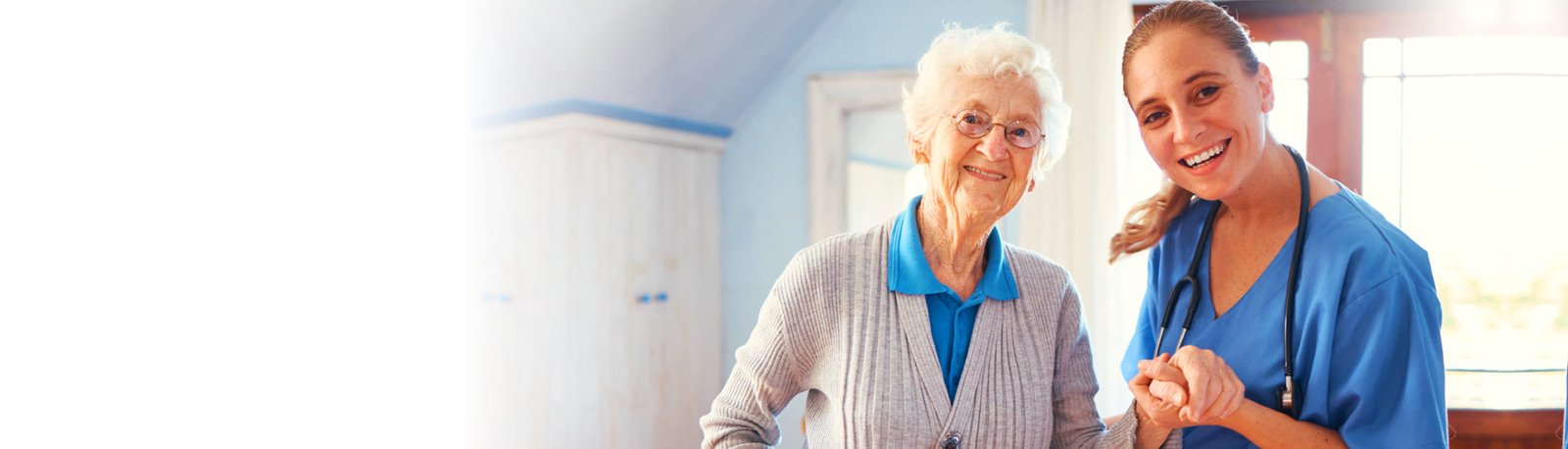 caregiver smiling with her elderly patient