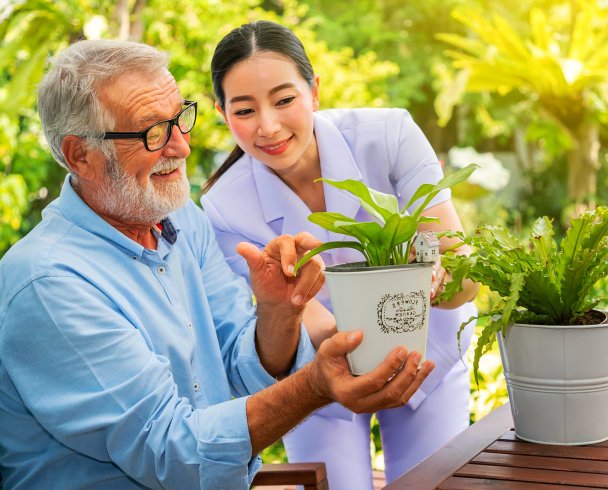 caregiver and her patient looking at plants