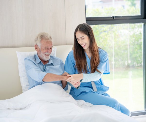 aide and senior man happy