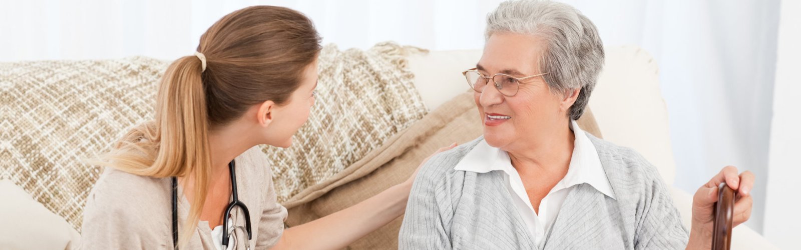 aide and senior woman looking at each other